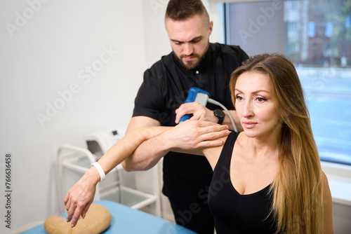 Middle-aged lady at a shock wave therapy session