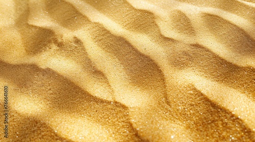 The image shows a beautiful sand texture with small grains of sand that are light brown in color. photo