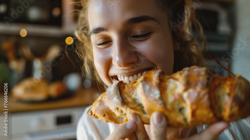 Close-up of woman eating fresh bread. Focus on bread