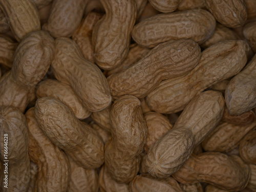 A pile of dried peanuts in shell close up. Healthy protein food