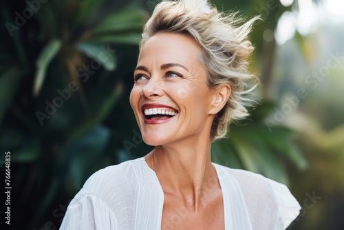 Portrait of beautiful mature woman with short hair smiling and looking away