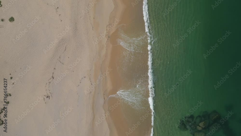 Aerial top down view moving above a sandy beach shore with small waves, Atlantic ocean, natural scene, Spain, Galicia, Rias Baixas, Pontevedra province
Aerial top down view moving above a sandy beach shore with small waves, Atlantic ocean, natural scene, Spain, Galicia, Rias Baixas, Pontevedra province