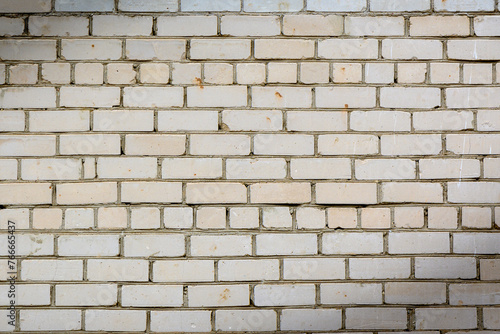 The wall is made of white sand-lime bricks. White brick masonry.