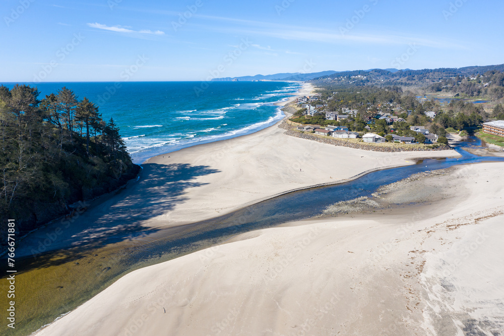 Aerial drone image of beautiful and empty beach of Neskowin, Oreogn, and the famous Proposal Rock, captured in 2020 during Covid-19 pandemic. Almost no people were enjoying spring sunshine that time