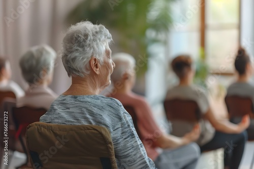 Elderly group practicing chair yoga focusing on upper back stretches and seated shoulder rolls for improved posture and reduced discomfort. Concept Chair Yoga, Elderly Health, Upper Back Stretches photo