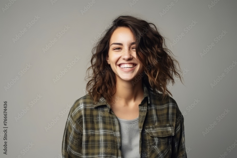 Portrait of a beautiful young woman smiling and looking at the camera Portrait of a beautiful young woman smiling and looking at the camera