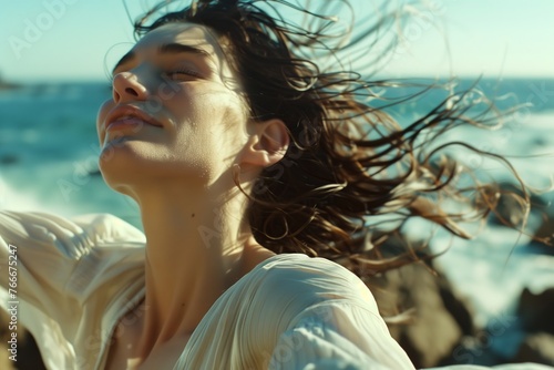 Seaside serenity - woman embracing coastal breezes