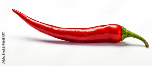 A vibrant red Chile de rbol, also known as Birds eye chili, is elegantly placed on a clean white surface, symbolizing the beauty and versatility of this natural food ingredient photo