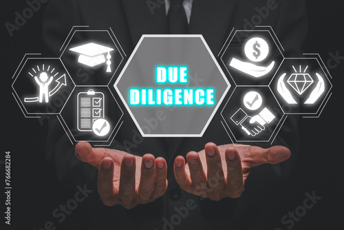 Due diligence concept, Businessman hands holding due diligence icon on cirtual screen.