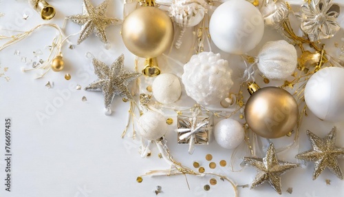 top view of white and golden christmas decorations arranged on a white background in a frame