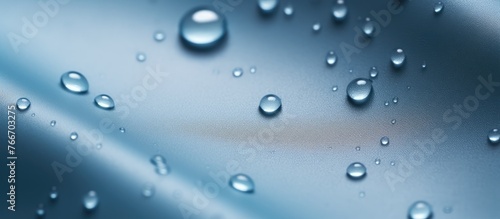 A detailed close-up view of a blue surface completely covered in small water droplets reflecting light beautifully