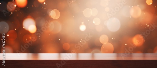 A rectangular brown wooden table with a blurred background of amber, orange tints and shades from Christmas lights. The setting creates a warm and festive event atmosphere