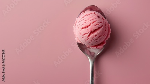 pink strawberry ice cream ball in a spoon, top view photo