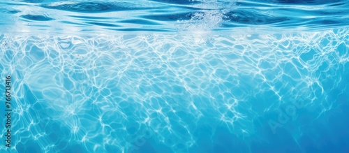 A detailed view of a wave rippling through the water in a swimming pool, creating a mesmerizing pattern