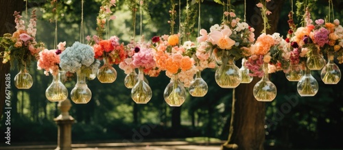 A line of flowerfilled vases hanging from a tree, creating a picturesque scene in contrast to the towering skyscrapers in the urban landscape