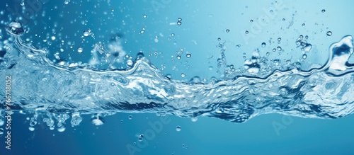 A close up of liquid water splashing against a vivid azure background, resembling a natural landscape under an electric blue sky
