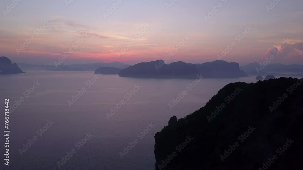 Aerial Panning Shot Of Tranquil Rock Formations In Rippled Sea Against Cloudy Sky During Sunset - Palawan, Philippines Aerial Panning Shot Of Tranquil Rock Formations In Rippled Sea Against Cloudy Sky During Sunset - Palawan, Philippines