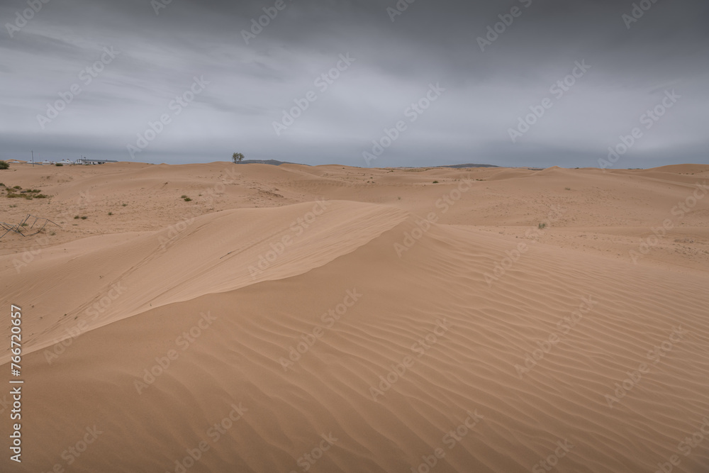 Sunset view of Sand dunes in XiangshaWan, or Singing sand Bay, China Sunset view of Sand dunes in XiangshaWan, or Singing sand Bay, China