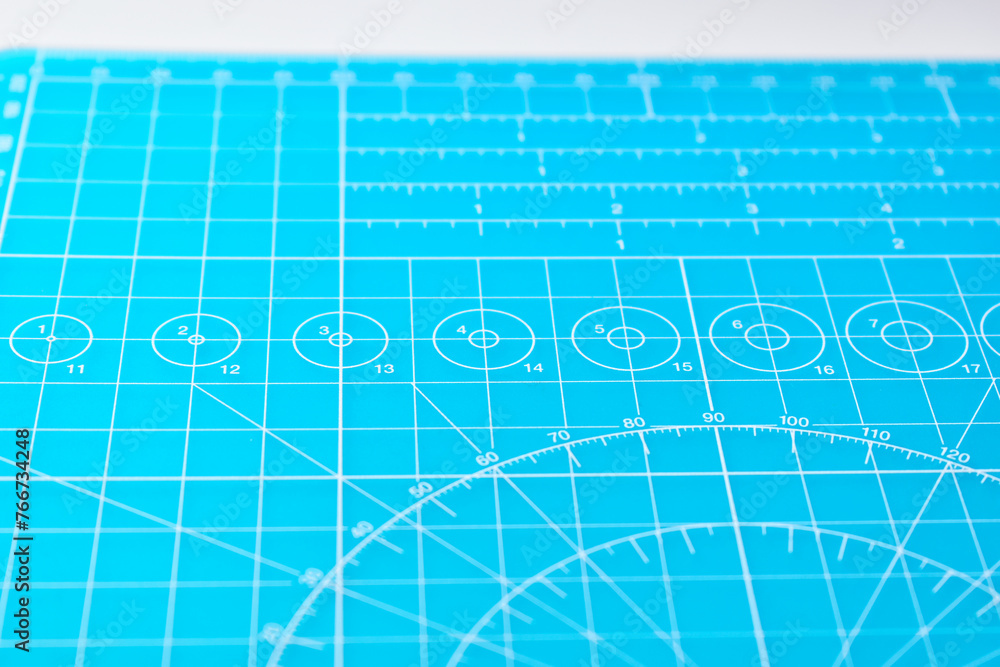 blue cutting mat board on white background with line and scale measure guide pattern for object art design, tool equipment of diy craft work