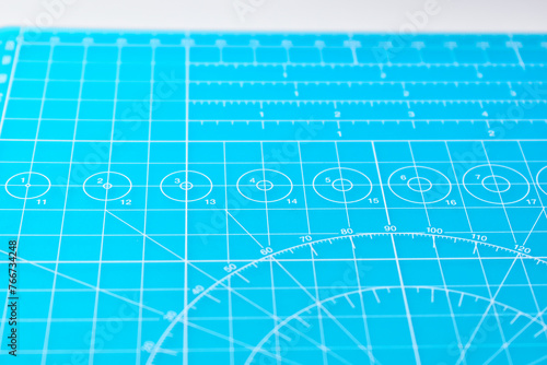 blue cutting mat board on white background with line and scale measure guide pattern for object art design, tool equipment of diy craft work © sutichak