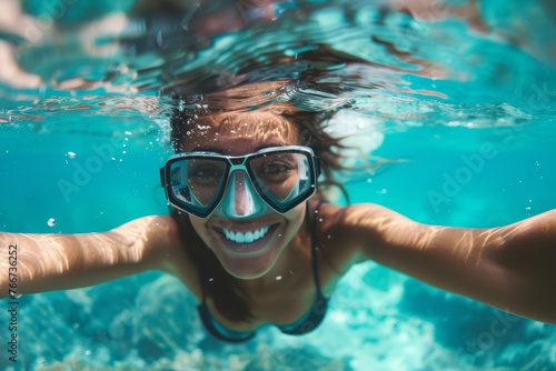 Happy girl underwater with goggles, bubbly and bright