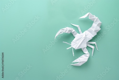 origami Scorpion on pastel green background photo