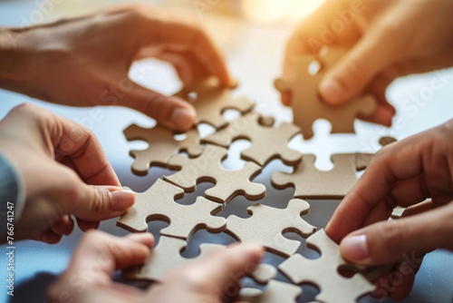 Hands join puzzle pieces, putting the jigsaws team together, business concept