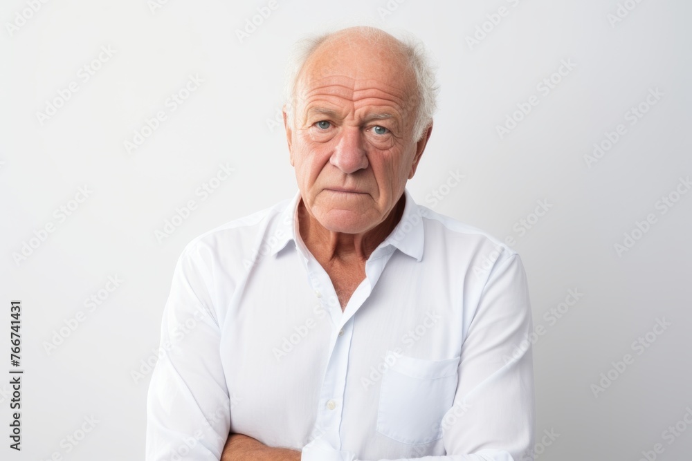 Portrait of an elderly man in a white shirt on a gray background Portrait of an elderly man in a white shirt on a gray background