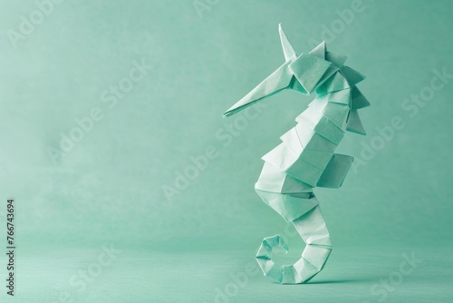 origami Seahorse on pastel green background photo