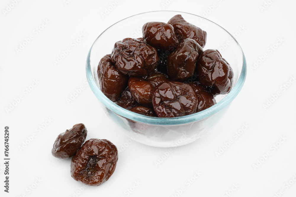 Many prunes in a glass bowl Isolated Background Many prunes in a glass bowl Isolated Background