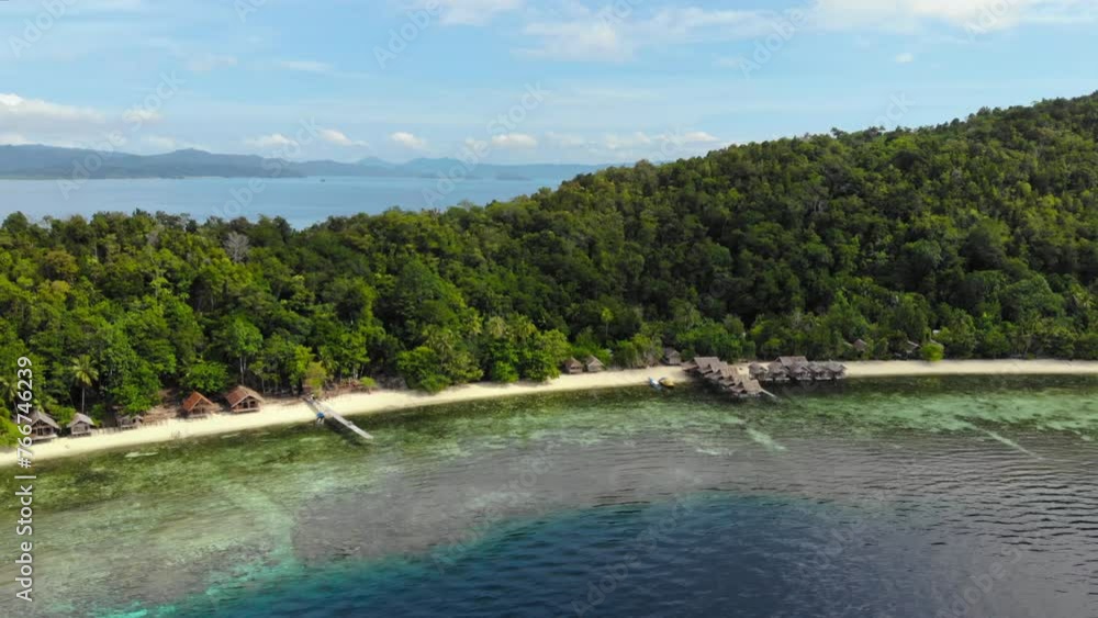 Aerial sideways shot showcases the breathtaking beauty of Kri Island in the Raja Ampat archipelago, Indonesia. Perfect for travel, adventure, and marine conservation projects. Aerial sideways shot showcases the breathtaking beauty of Kri Island in the Raja Ampat archipelago, Indonesia. Perfect for travel, adventure, and marine conservation projects.