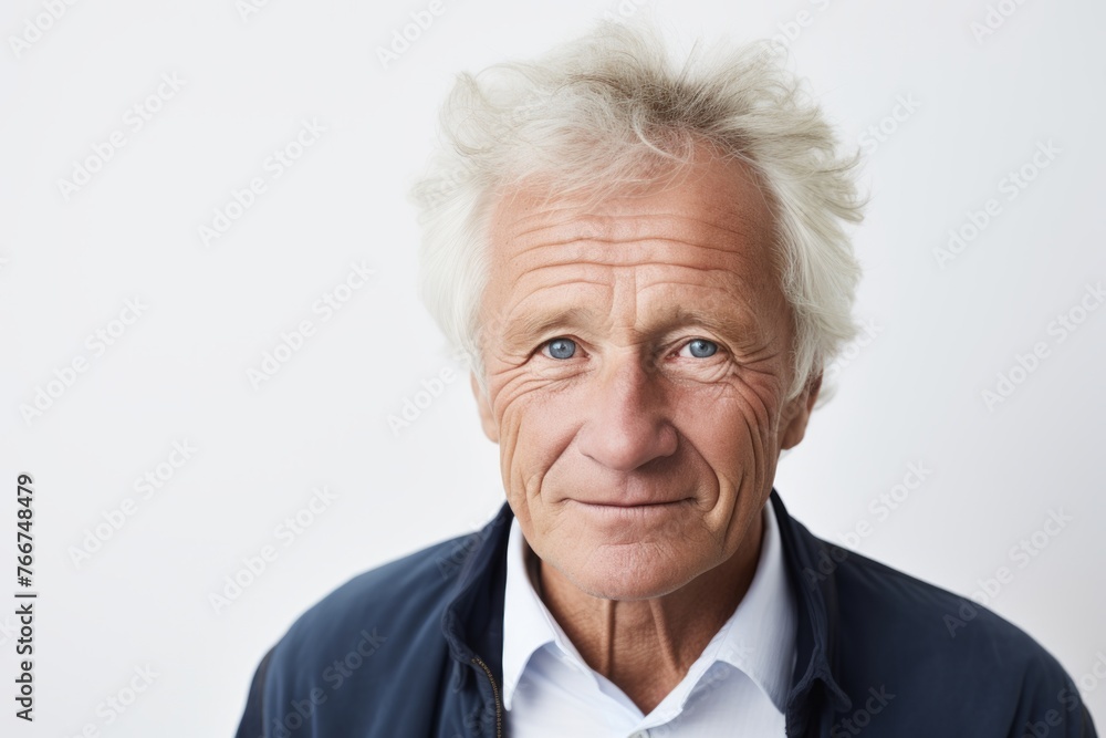 Portrait of senior man with grey hair and blue eyes looking at camera Portrait of senior man with grey hair and blue eyes looking at camera