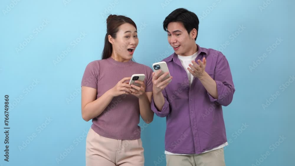 Asian couple using phone together
Asian couple using phone together