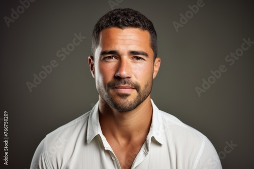 Portrait of a handsome man in a white shirt on a dark background