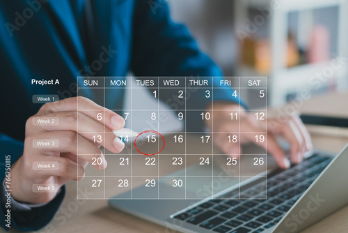 Calendar on the virtual screen interface. Businessman manages time for effective work.  Highlight appointment reminders and meeting agenda on the calendar. Schedule management concept. photo