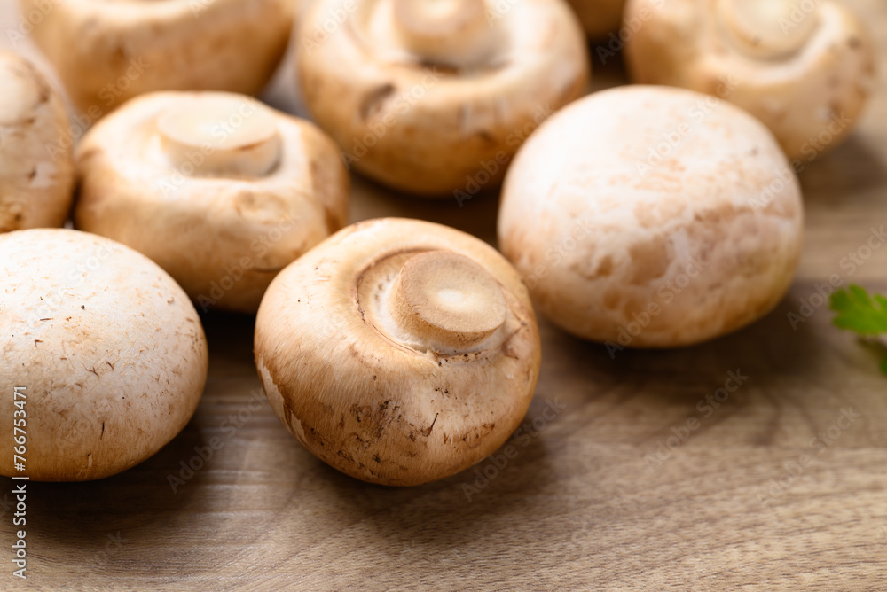 Fresh Champignon mushroom on wooden background