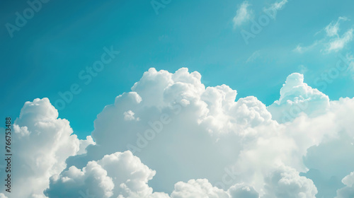 Large white clouds against a blue sky background © Venka