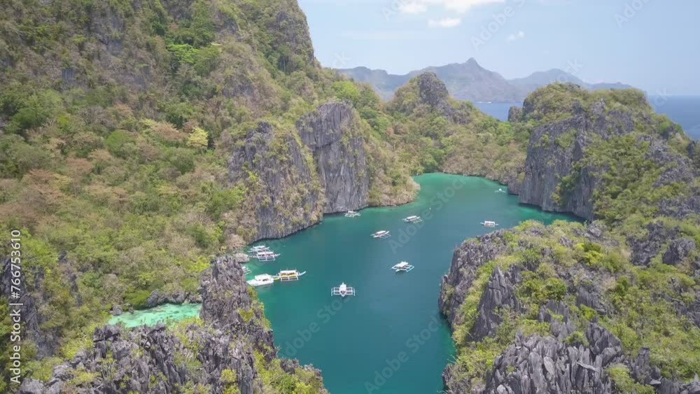 Aerial Shot Of Nautical Vessels Floating Amidst Mountains, Drone Flying Downwards On Sunny Day - Palawan, Philippines Aerial Shot Of Nautical Vessels Floating Amidst Mountains, Drone Flying Downwards On Sunny Day - Palawan, Philippines