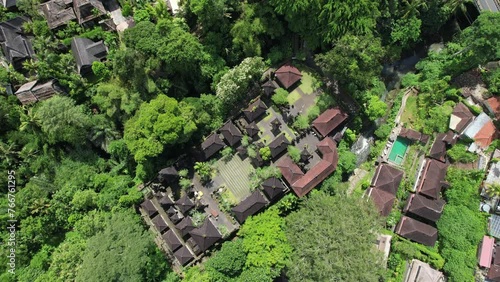 Tilt down aerial shot of Pura Gunung Lebah hindu temple on sunny day. Ubud, Bali, Indonesia. photo