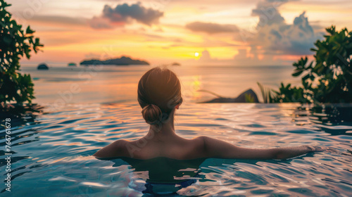 A beautiful young woman in a pool with a stunning mesmerizing ocean view