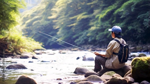 渓流で釣りをする日本人男性、川と自然の風景 photo