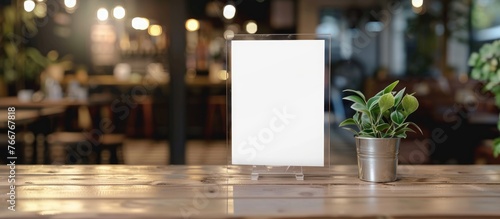 Label the empty menu frame at the Bar restaurant with white paper booklets in acrylic tent card holders on a wooden table in the cafeteria with a blurred background for customers to insert text.