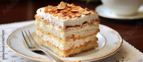 A delicious dessert consisting of a slice of cake on a plate with a fork. This baked good is made with staple food ingredients and is a popular choice for a sweet treat