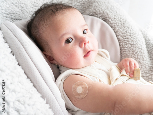 Quadro su tela Band-aid on baby's right arm after vaccination