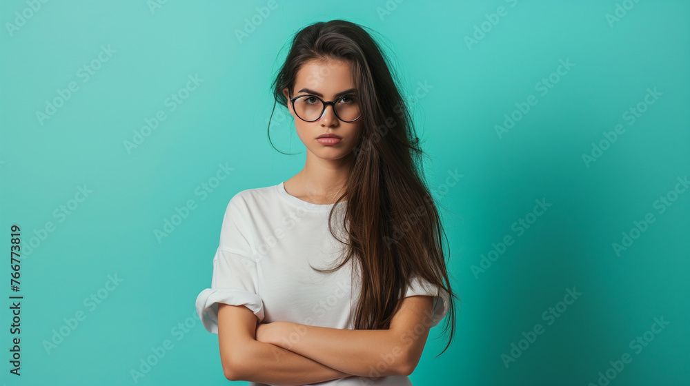 Full length portrait Portrait of young confused female student with glasses on eyes on teal color background professional photography. Full length portrait Portrait of young confused female student with glasses on eyes on teal color background professional photography.