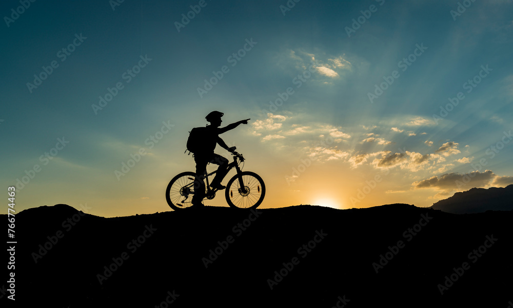 Fototapeta premium A person who goes for morning exercise on his bike witnesses the sunrise and creates new routes.