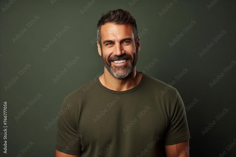 Portrait of a handsome mature man in a green t-shirt. Portrait of a handsome mature man in a green t-shirt.