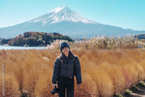 Photography Woman tourist with Fuji Mountain at Lake Kawaguchi, happy Traveler sightseeing Mount Fuji in Fujikawaguchiko, Yamanashi, Japan