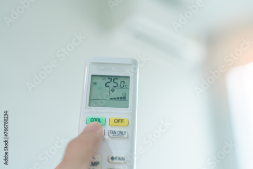 hand operating remote controller for adjust Air conditioner inside the room of office or house