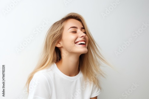 Portrait of a beautiful young blonde woman with long hair on a white background